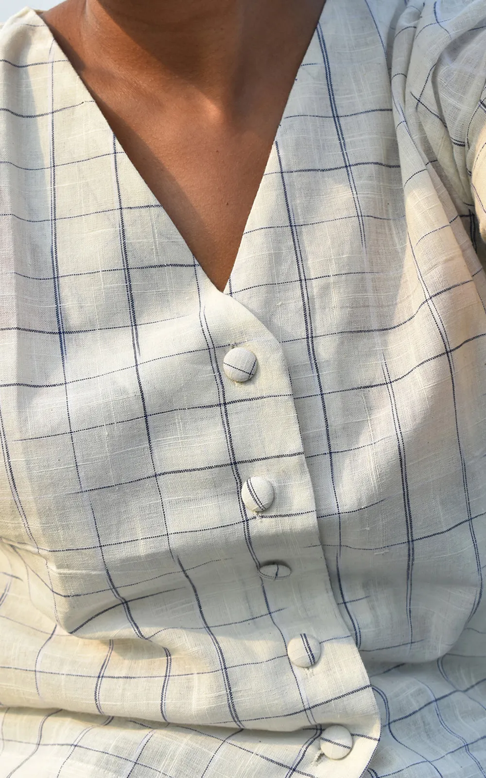 Blue disappearing check button down top